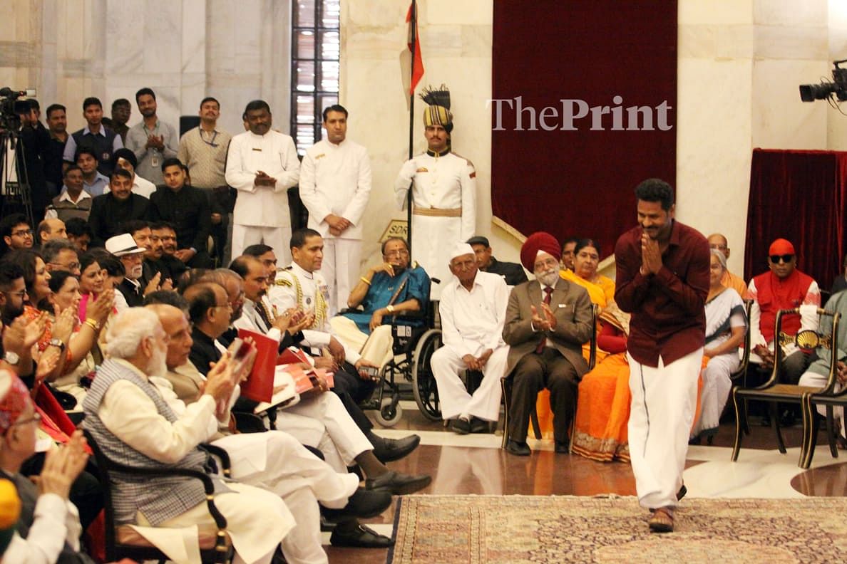 Choreographer and producer Prabhu Deva (right) greets senior ministers, who are sitting in the front row at the Padma Awards ceremony | Praveen Jain / ThePrint