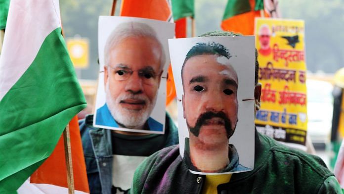 People wear masks of IAF pilot Abhinandan Varthaman and PM Narendra Modi during a rally in New Delhi | T. Narayan/Bloomberg