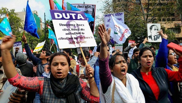 Members of the Delhi University Teacher's Association along with students from several universities stage a protest against the 13-point roster system in New Delhi | PTI
