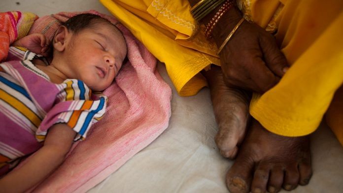 A child sleeps by its mother at the post delivery ward in a health center in Jindh |Prashanth Vishwanathan/Bloomberg