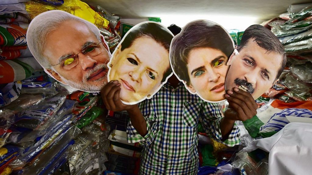 A salesman displays masks of PM Modi, Congress leaders Sonia Gandhi, Priyanka Gandhi and AAP leader Arvind Kejriwal at a shop, ahead of the Lok Sabha polls | PTI