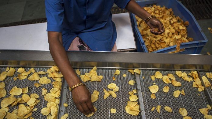 Representational image | A worker sorts fried crinkle-cut potato chips at a factory in UP | Prashanth Vishwanathan | Bloomberg