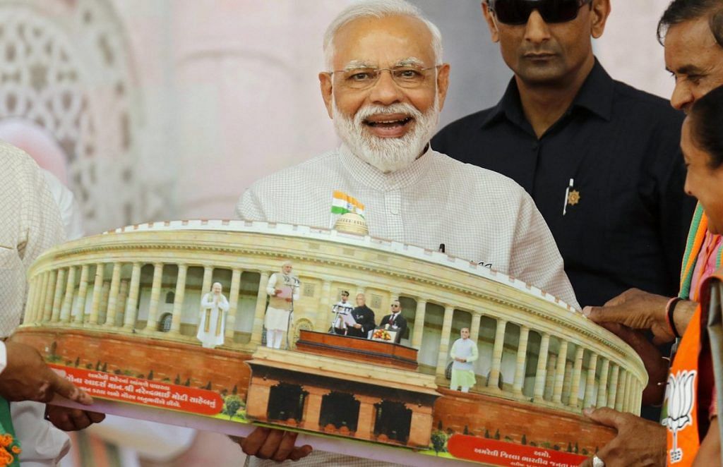 File photo of PM Narendra Modi being presented a memento during an election campaign, Gujarat | PTI