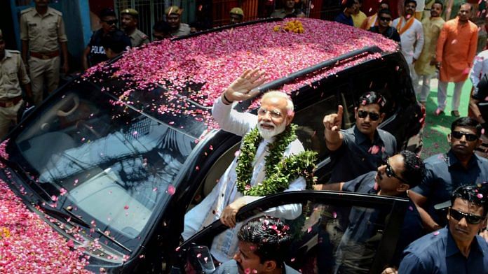 Narendra Modi waves at supporters as he leaves to file his nomination paper from Varanasi constituency | pti