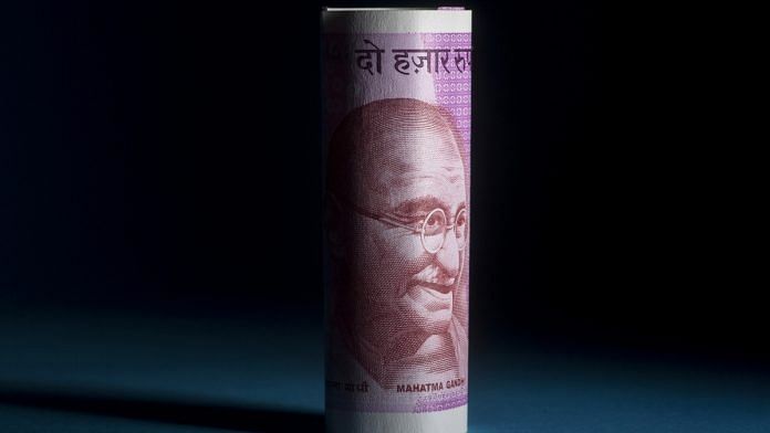 The portrait of Mahatma Gandhi is displayed on an Indian 2000 rupee banknote in an arranged photograph in Bangkok, Thailand