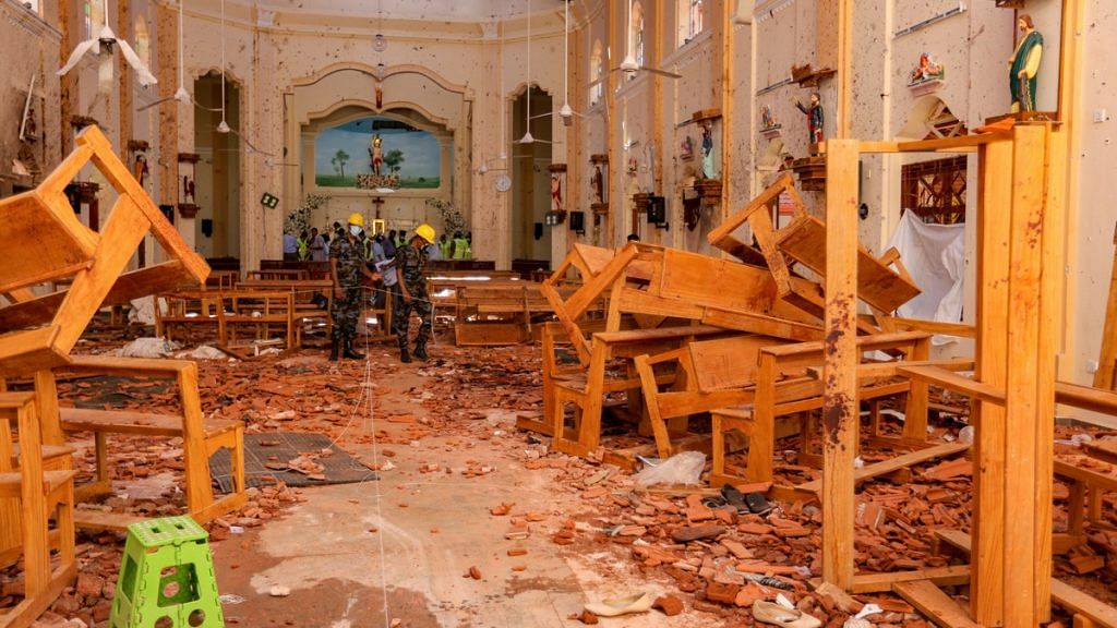 Sri Lankan soldiers inspect the damage inside St. Sebastian's Church where a bomb blast took place in Negombo, Sri Lanka