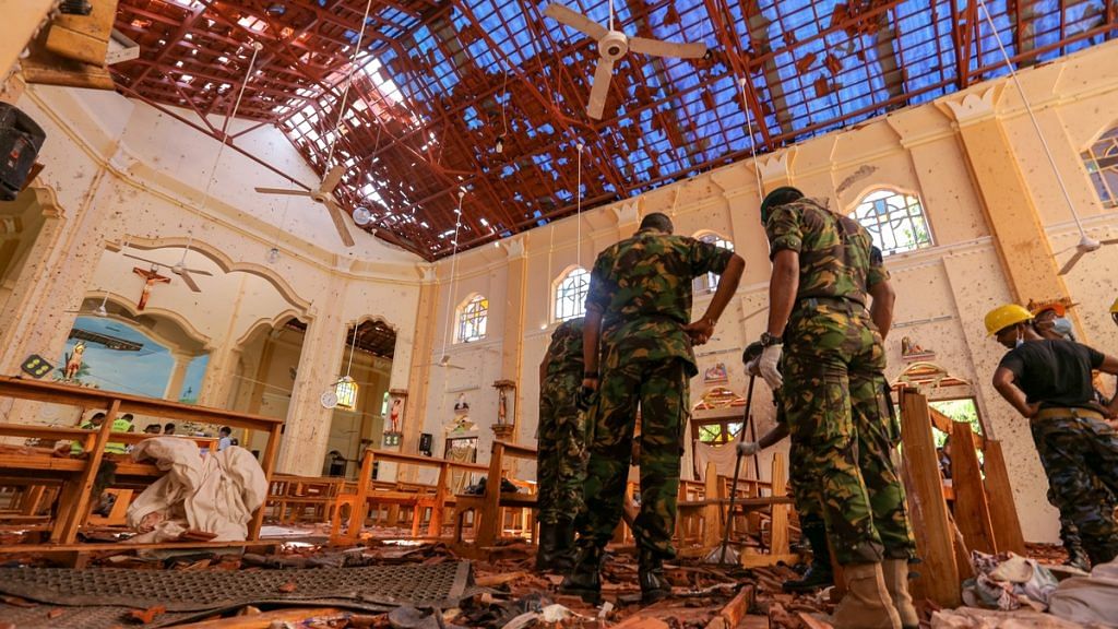 Sri Lankan soldiers inspect the damage inside St. Sebastian's Church, Sri Lanka | Tharaka Basnayaka/Bloomberg