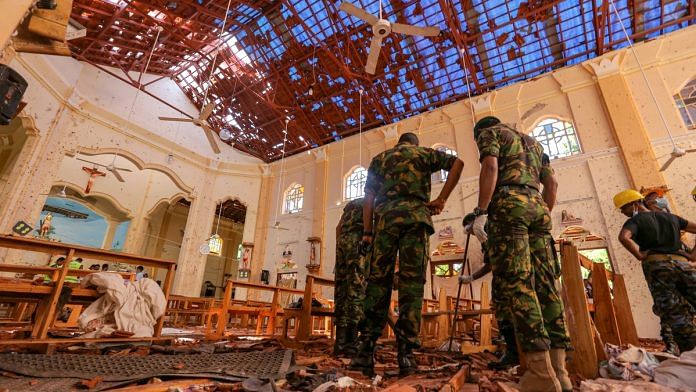 Sri Lankan soldiers inspect the damage inside St. Sebastian's Church, Sri Lanka | Tharaka Basnayaka/Bloomberg