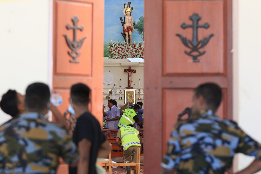 Sri Lankan soldiers inspect the damage inside St. Sebastian's Church where a bomb blast took place in Negombo, Sri Lanka. | Tharaka Basnayaka | Bloomberg