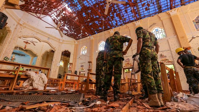 Sri Lankan soldiers inspect the damage inside St. Sebastian's Church where a bomb blast took place in Negombo, Sri Lanka