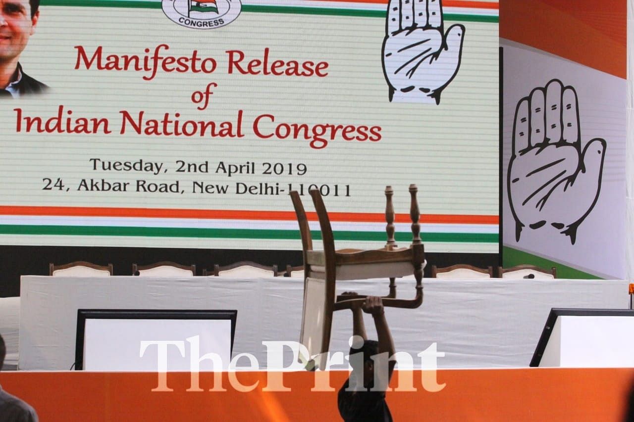 Kissa Kursi Ka : A party worker carries away a seat before the event | Praveen Jain/ThePrint