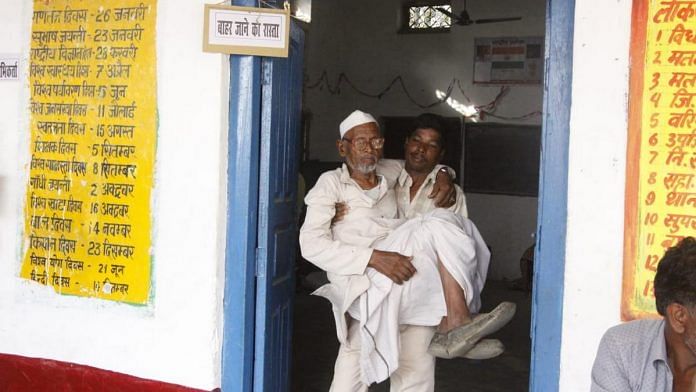 A young man carrying a senior citizen to cast his vote
