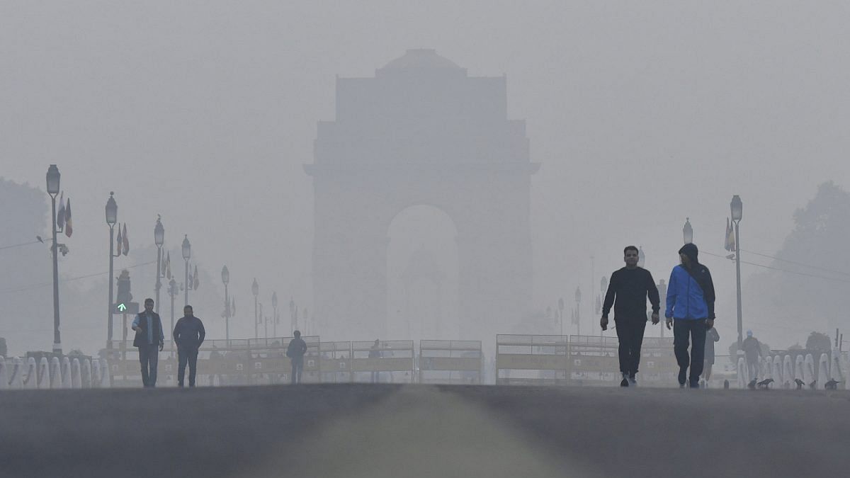 Finally! World's Worst Air Emerges as an Election Issue in India Pedestrians walk past the India Gate monument shrouded in smog in New Delhi.