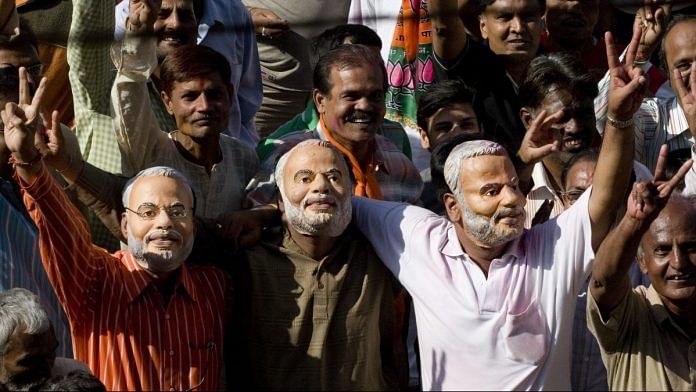 Supporters of BJP wearing masks of Narendra Modi | Sanjit Das/Bloomberg News