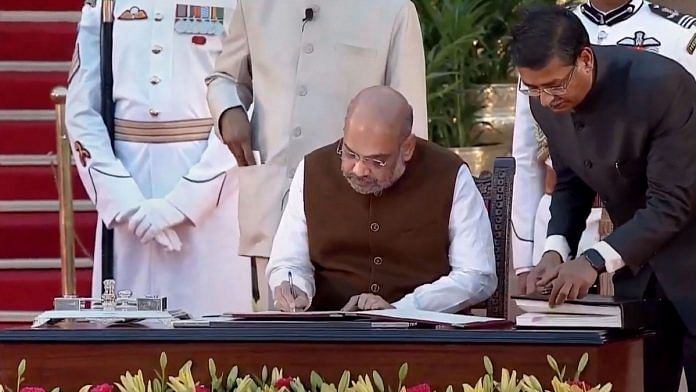 File photo | BJP President Amit Shah signs a register after taking oath as a union minister, at Rashtrapati Bhavan | PTI