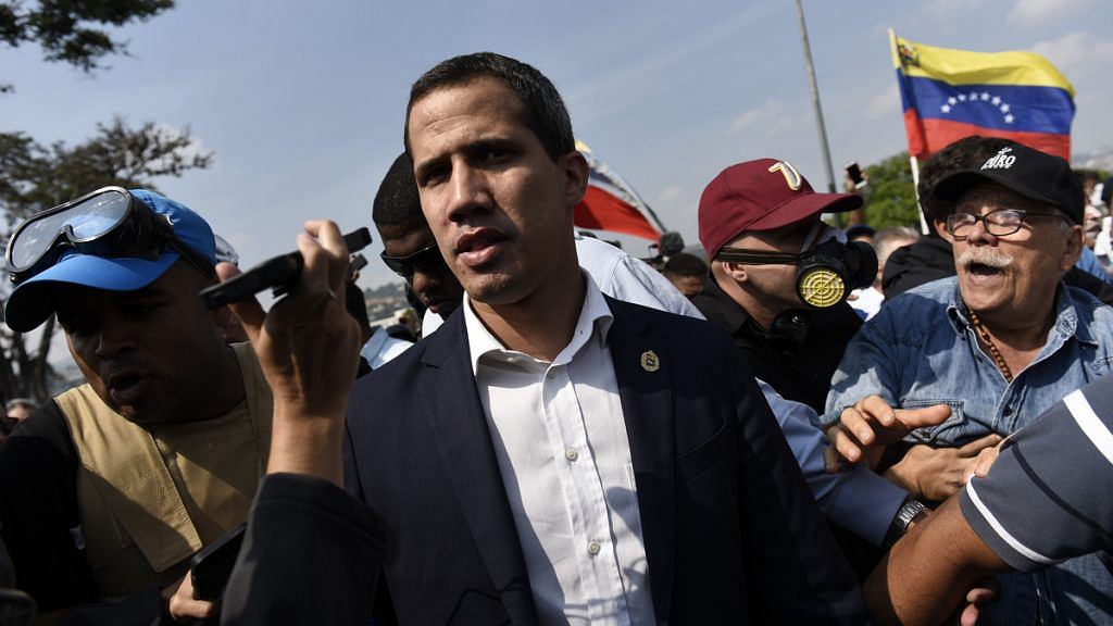 Juan Guaido leads a crowd protest pressing for military uprising against President Maduro