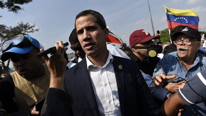 Juan Guaido leads a crowd protest pressing for military uprising against President Maduro