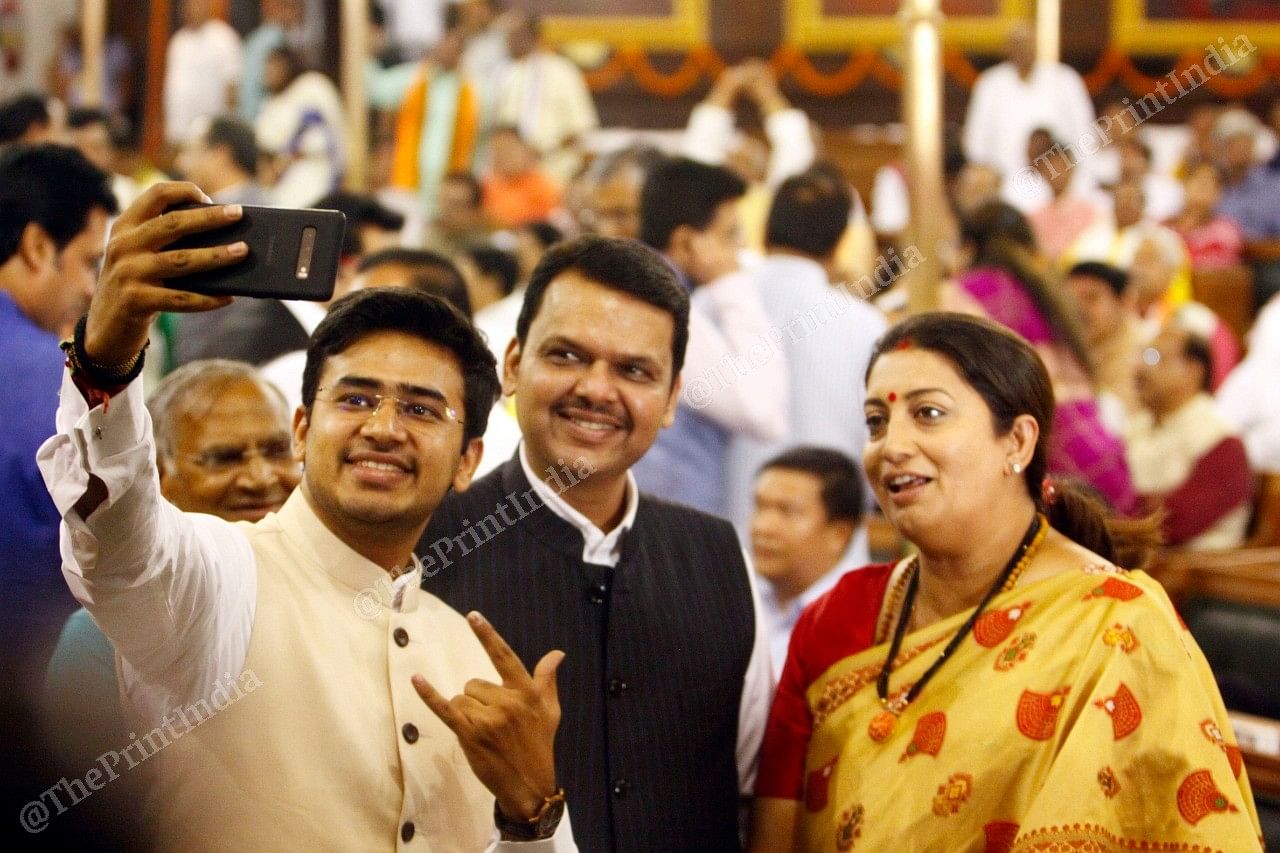 The youngest BJP MP from Bengaluru South Tejaswi Surya clicks a selfie with Devendra Fadnavis (centre) and newly elected MP Smriti Irani | Photo: Praveen Jain | ThePrint