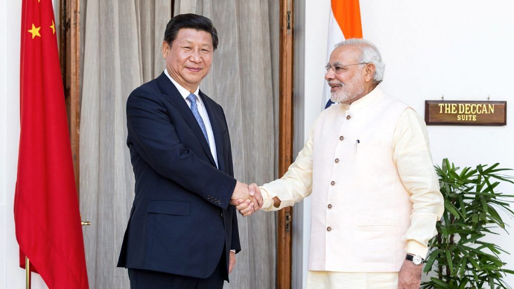 Narendra Modi shakes hands with Xi Jinping, China's president | Photo: Graham Crouch | Bloomberg