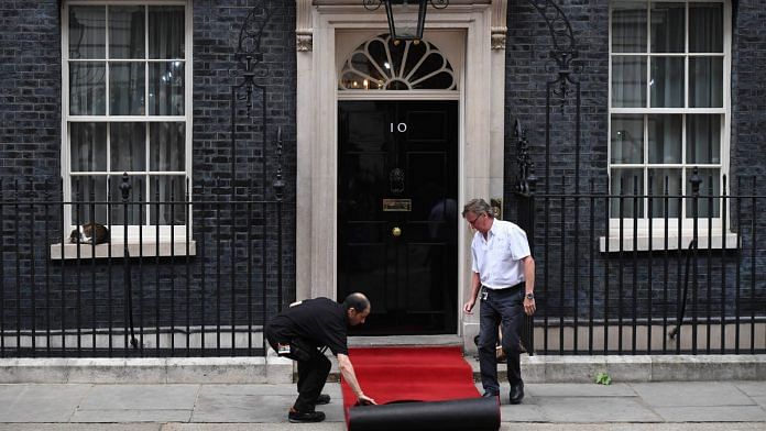 Workers prepare a red carpet outside 10 Downing Street