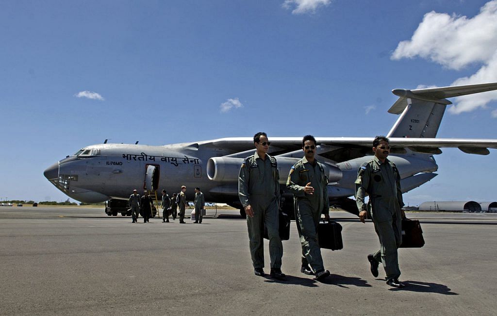 Indian air force pilots walk away from their IL-76 medium cargo jet after landing