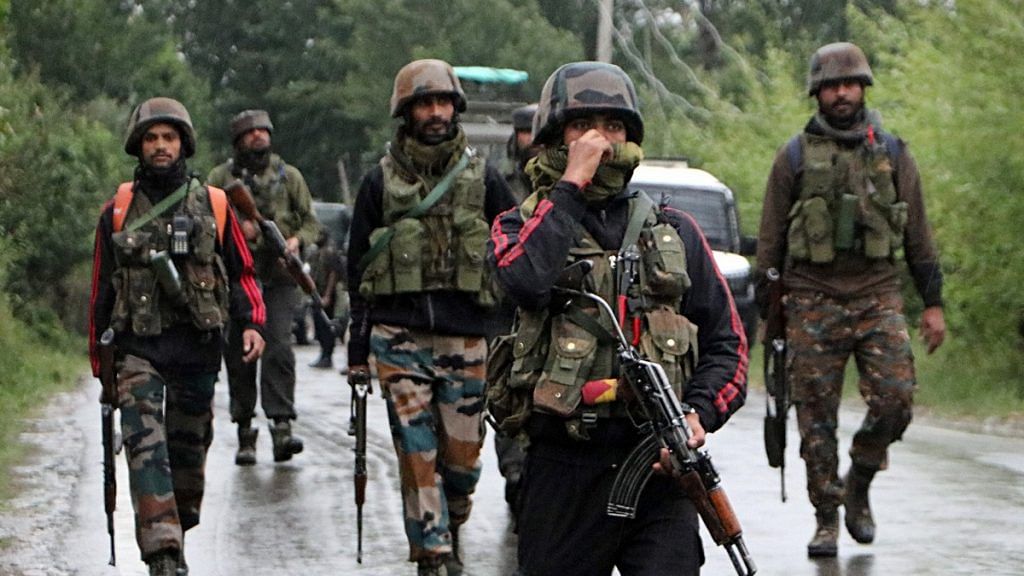 Army personnel take position after an IED blast in Pulwama