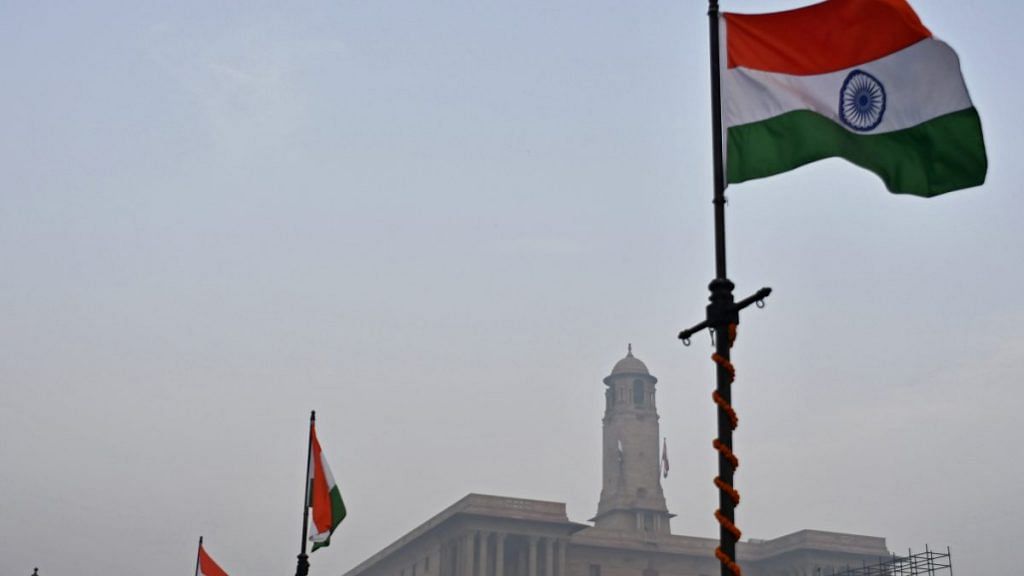 Indian national flags fly outside the North Block, which houses the Ministries of Finance and Home Affairs, in New Delhi | Anindito Mukherjee/Bloomberg