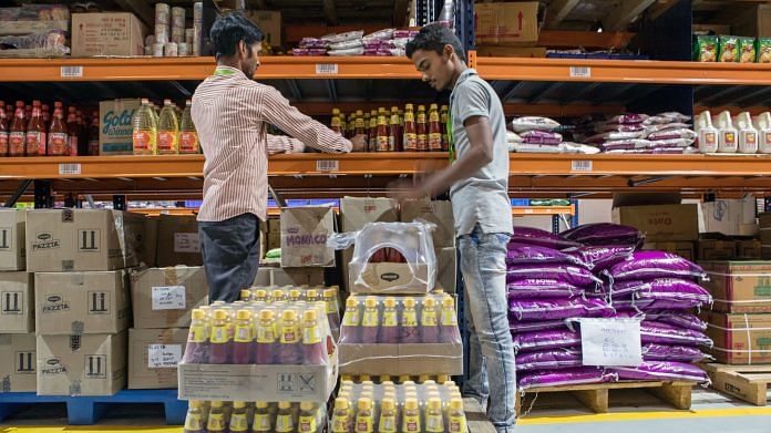 Workers unload crates of sauce onto shelves at a warehouse of Bigbasket. (Representational Image) | Photographer: Samyukta Lakshmi | Bloomberg