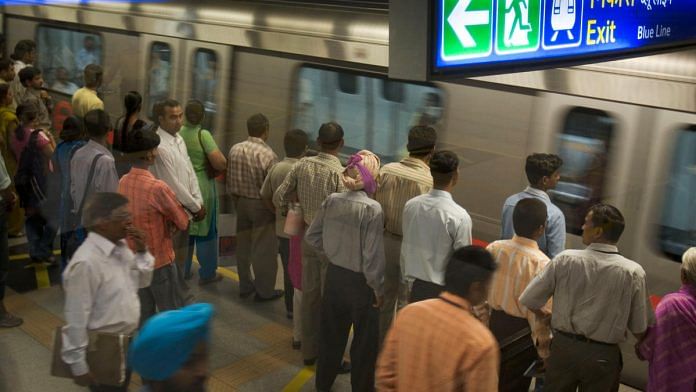 Commuters wait for a train at Rajiv Chowk Metro station