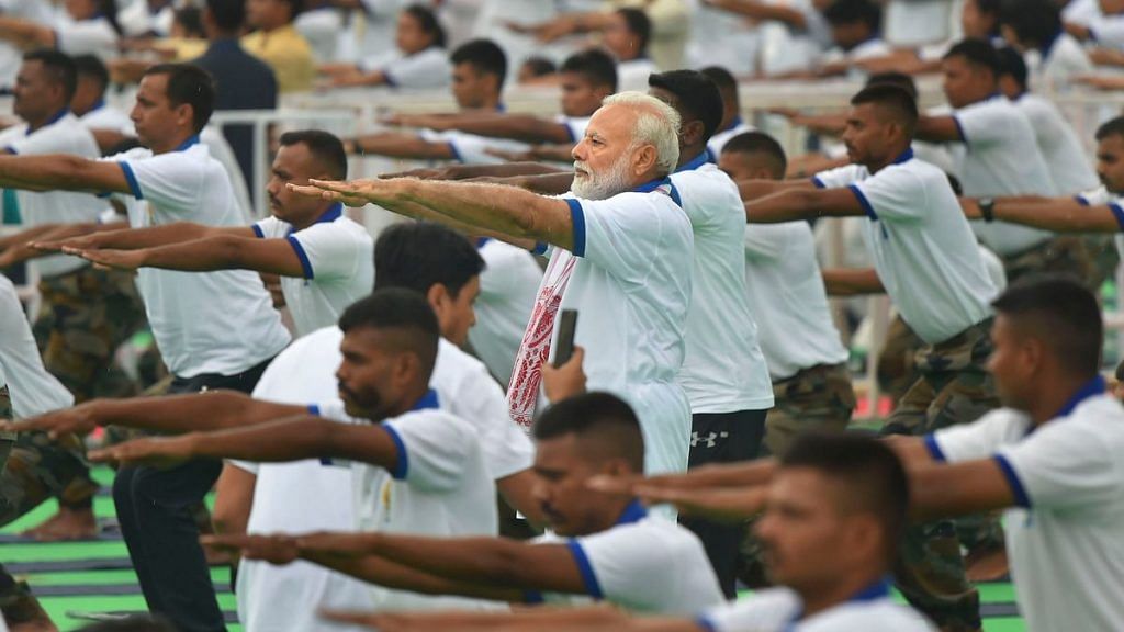 PM Narendra Modi along with other participants performs yoga during the 5th International Day of Yoga in Ranchi