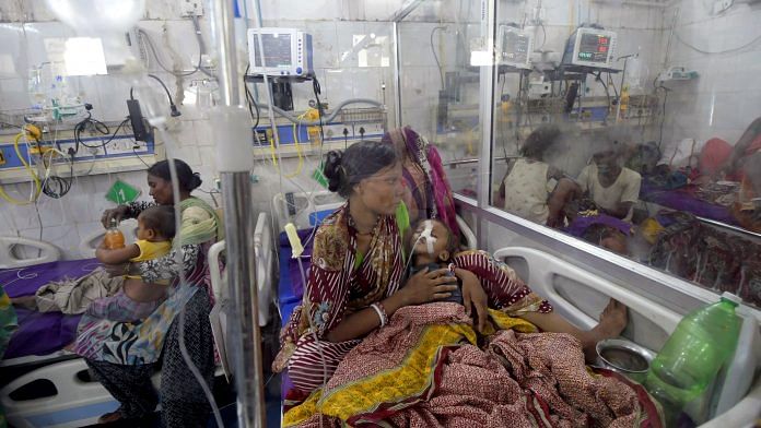 Mothers hold their infants, who are being treated for Acute Encephalitis Syndrome in Muzaffarpur. | ANI Photos