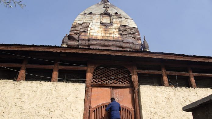 Irfan Ahmed opens the gates of the Rama Koul Temple, Srinagar | Nawal Watali