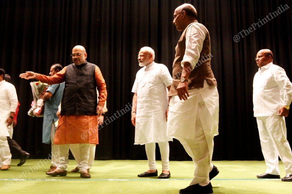 Amit Shah ushers PM Narendra Modi and Rajnath Singh as Thawar Chand Gehlot stands behind 
