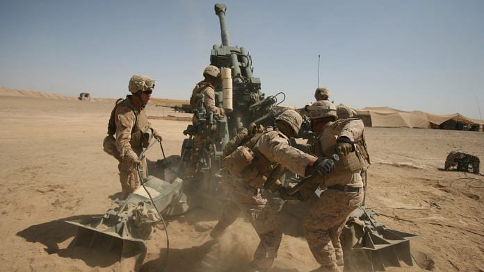 U. S. Marines ram a satellite-guided Excalibur XM982 Precision Engagement Projectile during a fire mission. | Photo by Sgt Earnest J. Barnes | Released by US Army