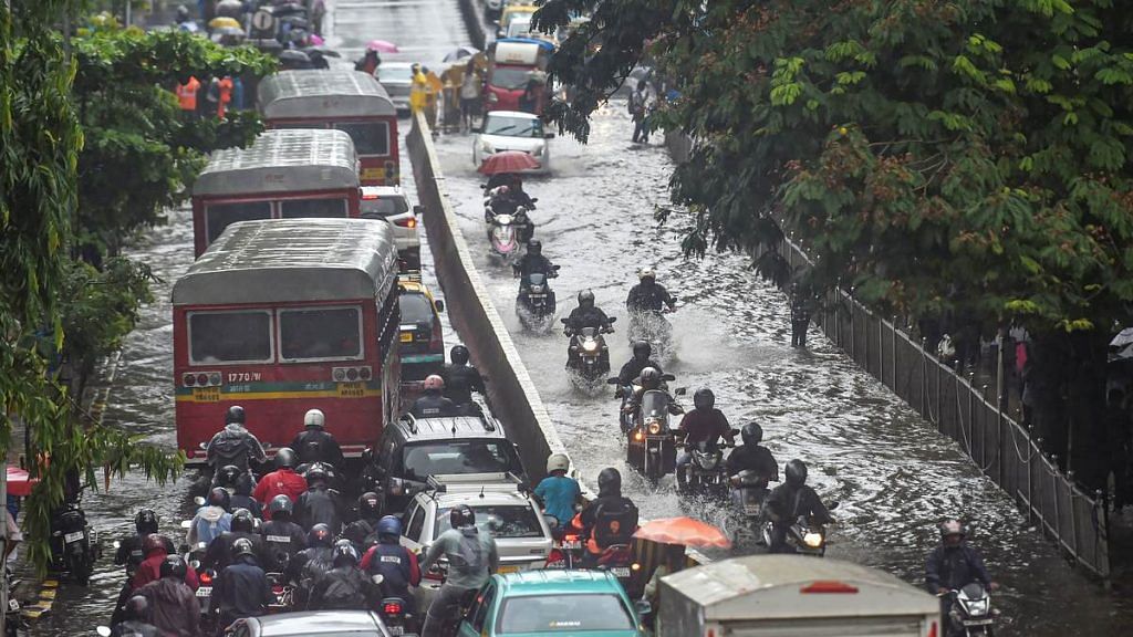 Vehicles move through waterlogged streets during heavy monsoon rain, in Mumbai, on 1 July, 2019 | Photo: Mitesh Bhuvad | PTI