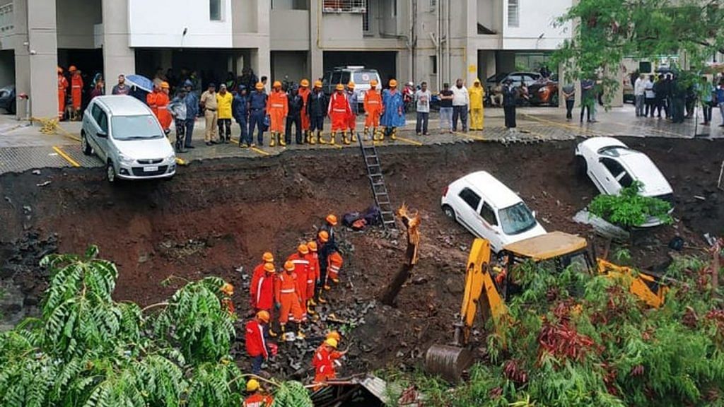 NDRF team carry out rescue operations after a wall collapsed near Talab masjid at Kondhwa in Pune