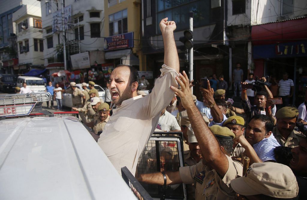Jammu & Kashmir police detain a member of Youth Congress during a protest