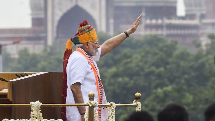 Prime Minister Narendra Modi waves at the crowd from the ramparts of the historic Red Fort