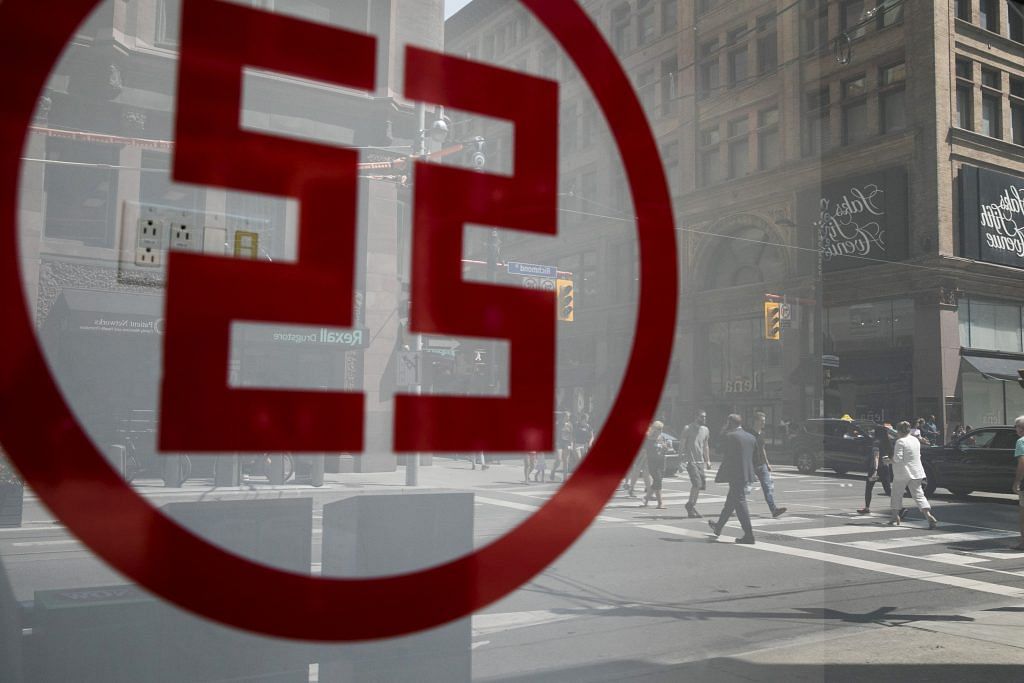 Pedestrians are seen reflected in the window of a Industrial and Commercial Bank of China Ltd. (ICBC) | Photographer: Brent Lewin | Bloomberg