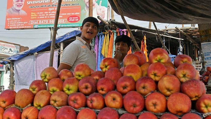 A street vendor sells apples in Modinagar, Uttar Pradesh