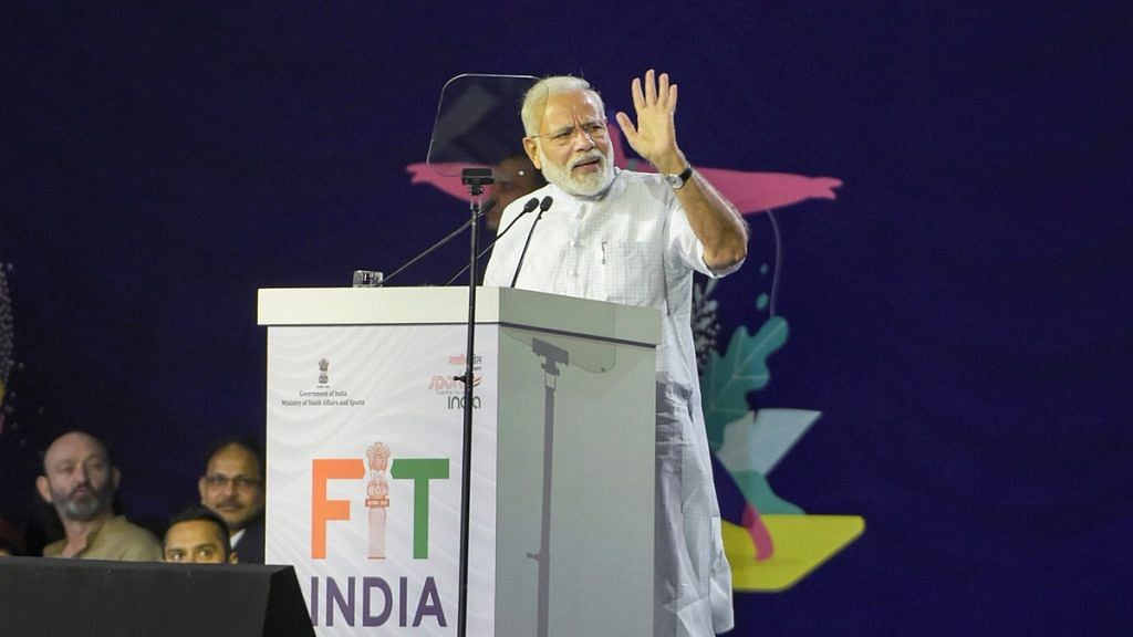 PM Modi addresses during the launch of Fit India Movement on National Sports Day, at Indira Gandhi Indoor Stadium in New Delhi | PTI