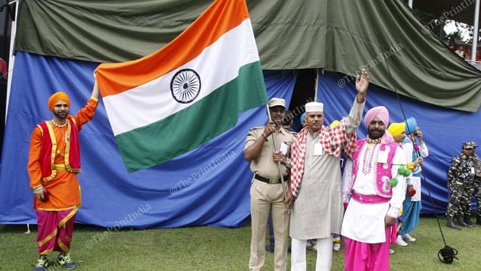A security personnel and performers pose for the camera during the event | Praveen Jain | ThePrint Team