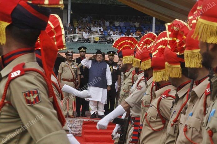 Governor Satya Pal Malik salutes a passing contingent at the Independence Day parade at Sher-i-Kashmir stadium | Praveen Jain | ThePrint