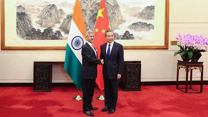 External Affairs Minister S Jaishankar shakes hands with Chinese Foreign Minister Wang Yi during a meeting at Diaoyutai State Guesthouse, in Beijing. | PTI