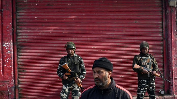 Members of the security forces stand guard in front of a shuttered store in Srinagar, Jammu and Kashmir| File photo | Anindito Mukherjee/Bloomberg