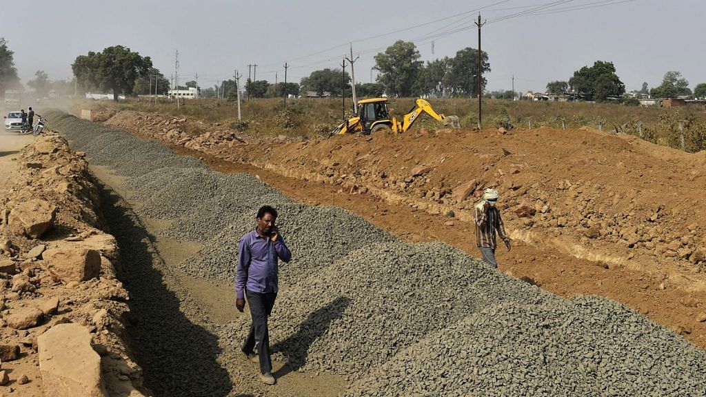 Workers at a road construction site pictured in Bhopal, Madhya Pradesh | Anindito Mukherjee | Bloomberg