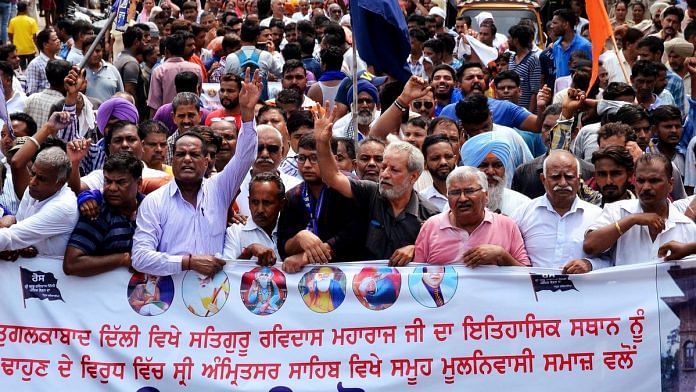 Members of Guru Ravidas Sabha Punjab protest march the demolishing of Guru Ravidas temple in Delhi. | ANI
