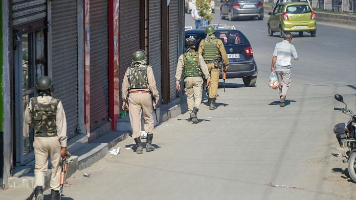CRPF personnel patrol a street as situation in Kashmir continues to be tense and uncertain, in Srinagar. | PTI