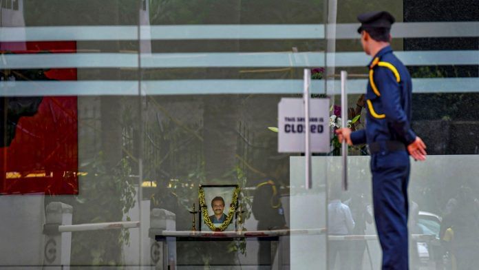 A garlanded photo of VG Siddhartha at a Cafe Coffee Day outlet, Bengaluru, 31 July, 2019 | PTI Photo