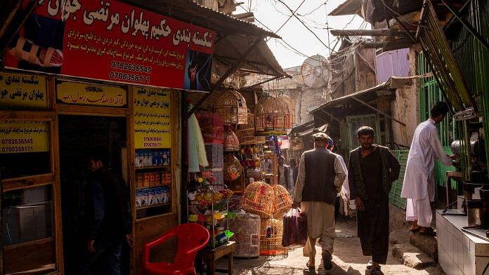 Pedestrians walk through an alley at the Kah Froshi bird market in Kabul, Afghanistan | Photographer: Jim Huylebroek | Bloomberg